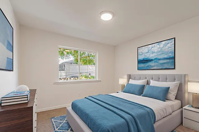 a bathroom with a granite countertop sink a toilet and a mirror