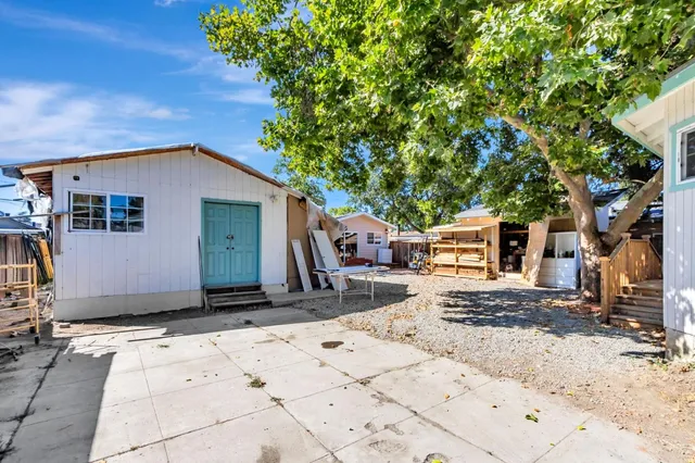 a view of a house with yard and sitting area