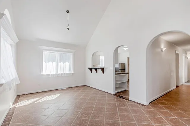 a dining room with furniture and window