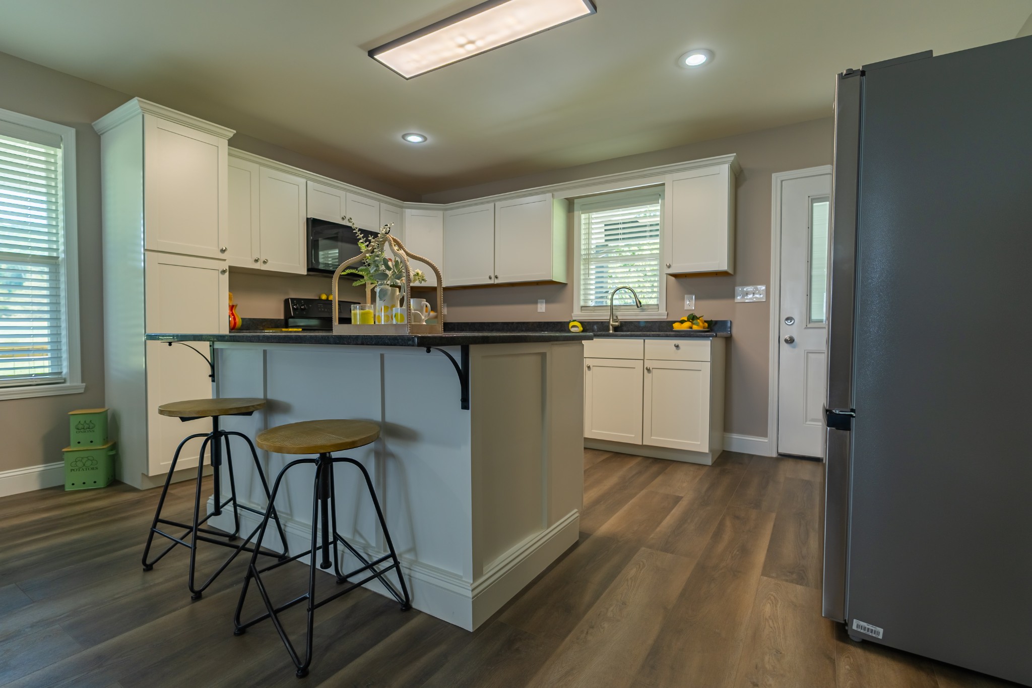 34 Bailey Road Decherd, TN 37324 - Photo 17 of 27 a kitchen with stainless steel appliances a table chairs refrigerator and cabinets