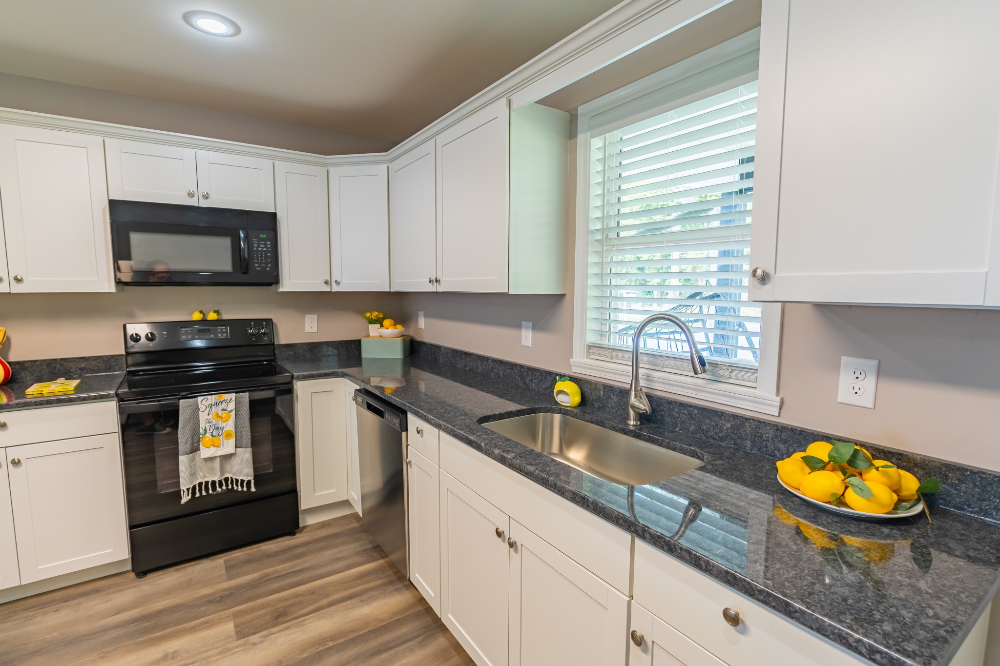 34 Bailey Road Decherd, TN 37324 - Photo 18 of 27 a kitchen with stainless steel appliances granite countertop a sink a stove and a wooden cabinets