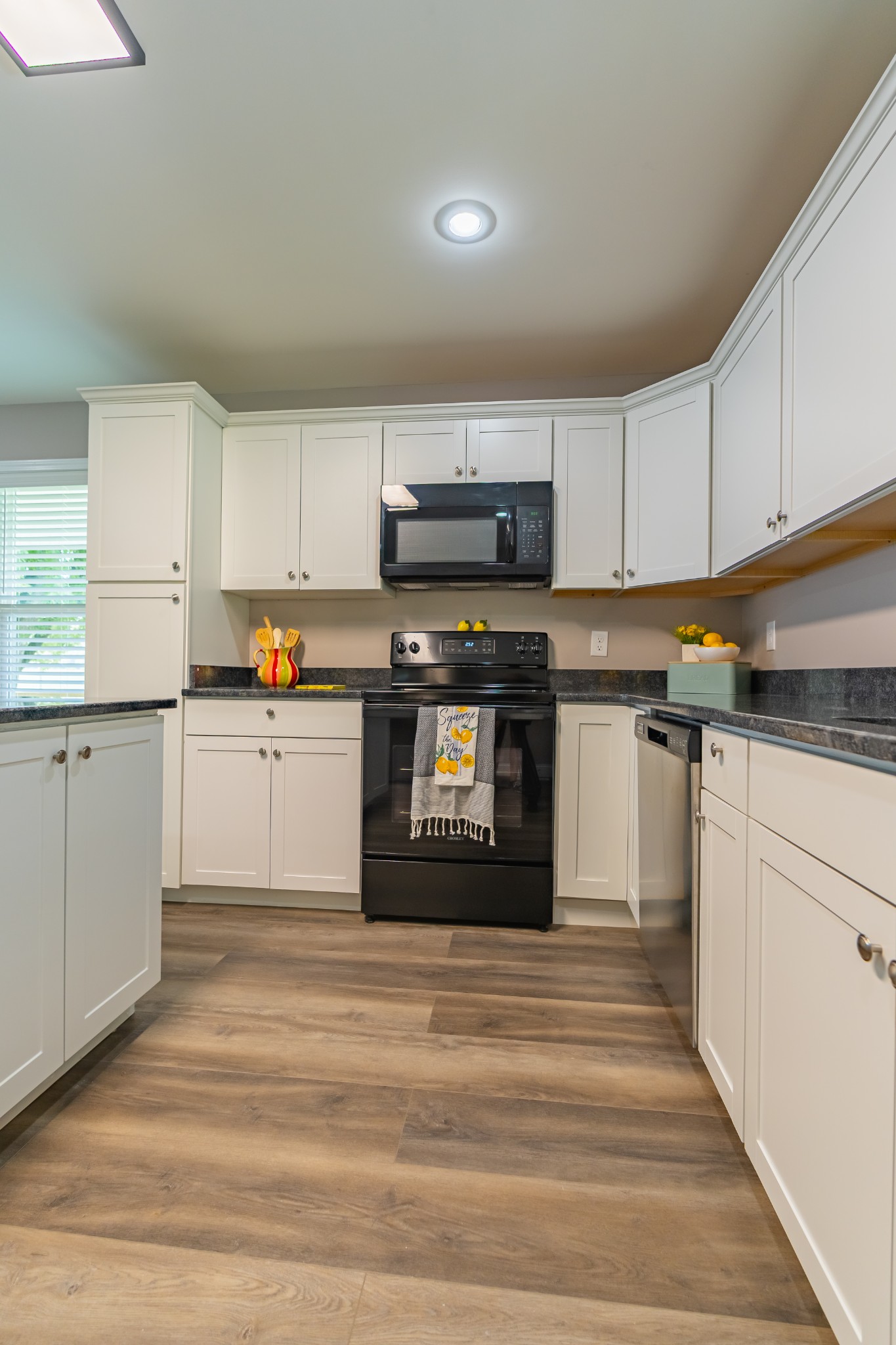34 Bailey Road Decherd, TN 37324 - Photo 20 of 27 a kitchen with stainless steel appliances granite countertop a stove and white cabinets