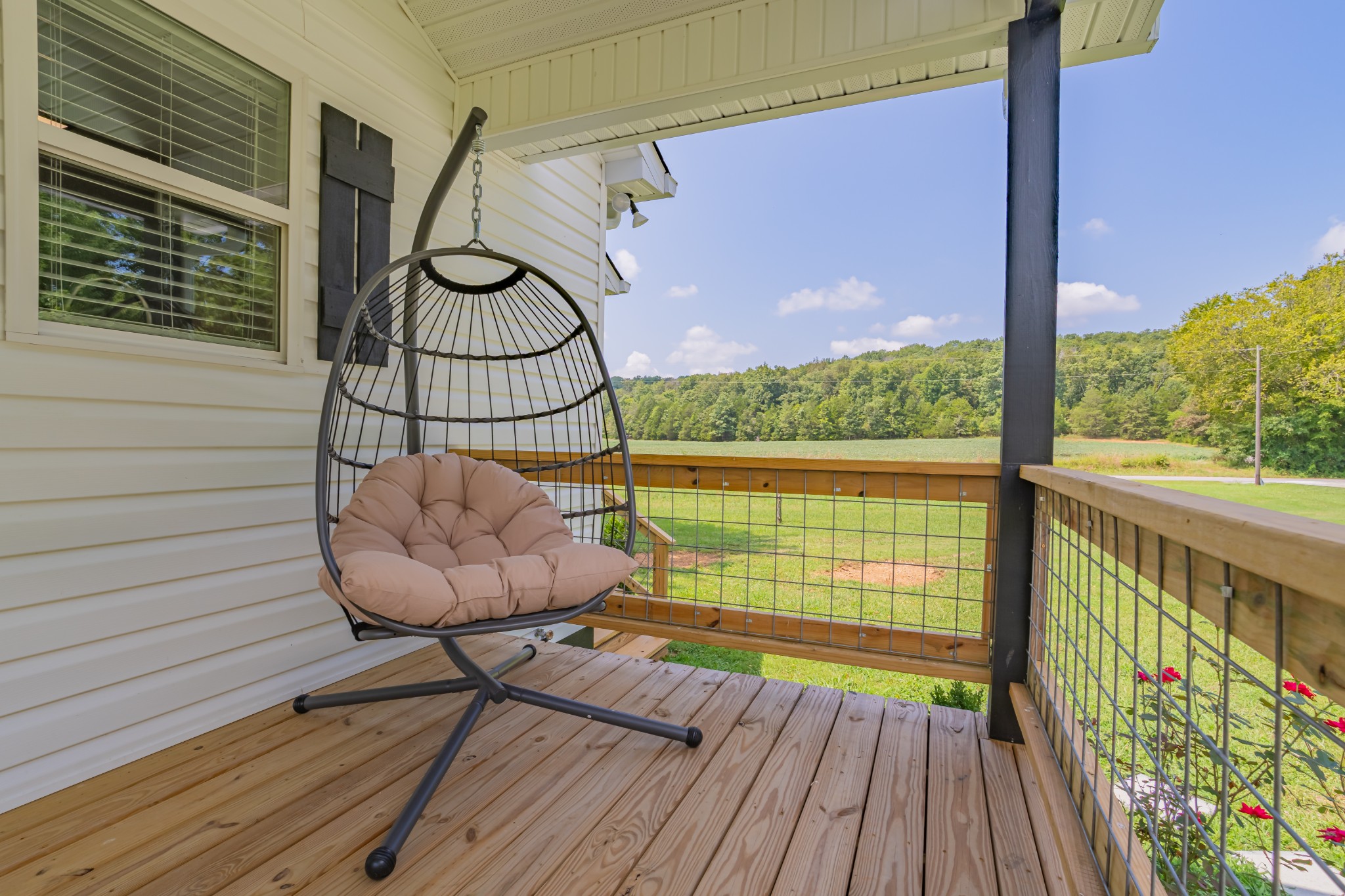 34 Bailey Road Decherd, TN 37324 - Photo 9 of 27 a view of a balcony with chair and wooden floor