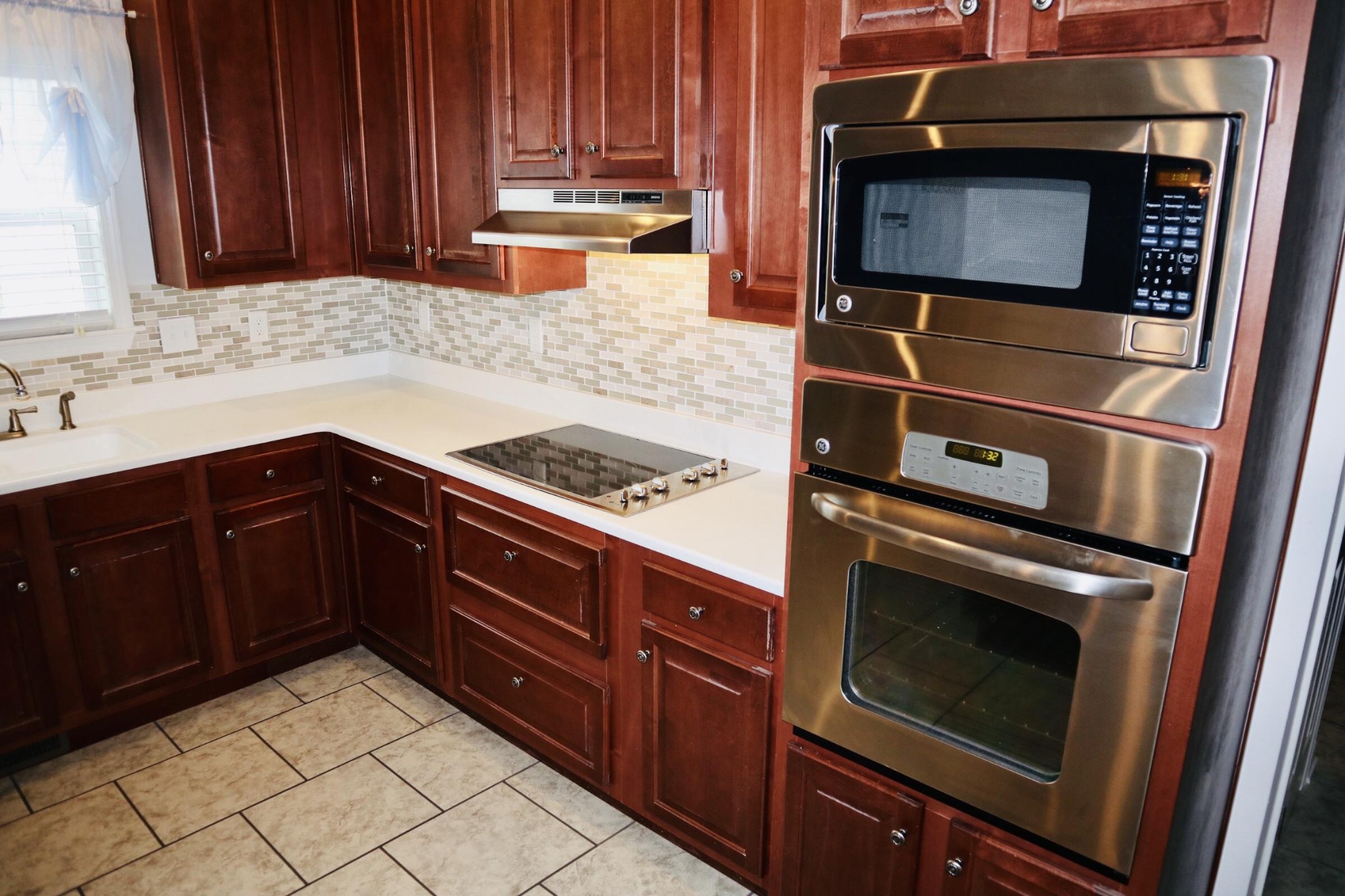 834 East Raccoon Valley Drive Heiskell, TN 37754 - Photo 6 of 20 a kitchen with granite countertop wooden cabinets and a stove top oven