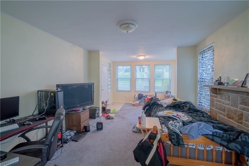 5407 Verona Road Verona, PA 15147 - Photo 14 of 25 a bed room with furniture and a flat screen tv