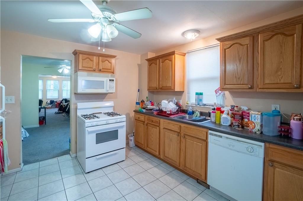 5407 Verona Road Verona, PA 15147 - Photo 16 of 25 a kitchen with a stove cabinets and window