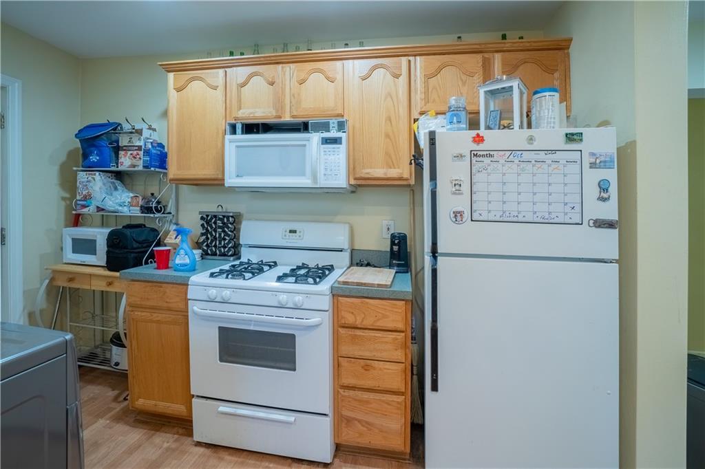 5407 Verona Road Verona, PA 15147 - Photo 8 of 25 a kitchen with stainless steel appliances granite countertop a stove and a refrigerator