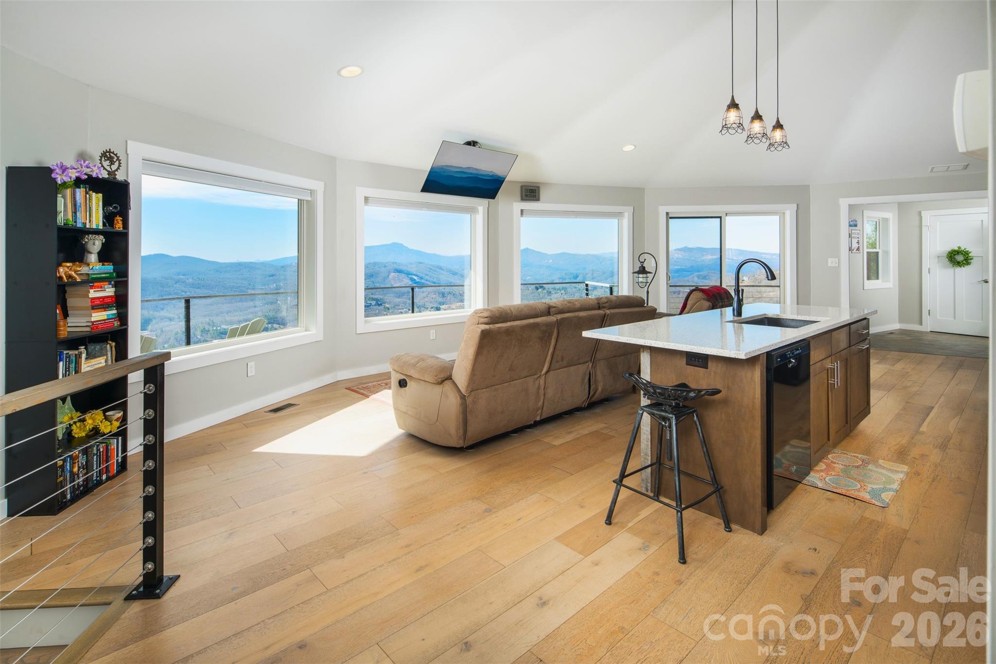 448 Howards Knob Road Boone, NC 28607 - Photo 16 of 38 a living room with furniture a rug and a book shelf