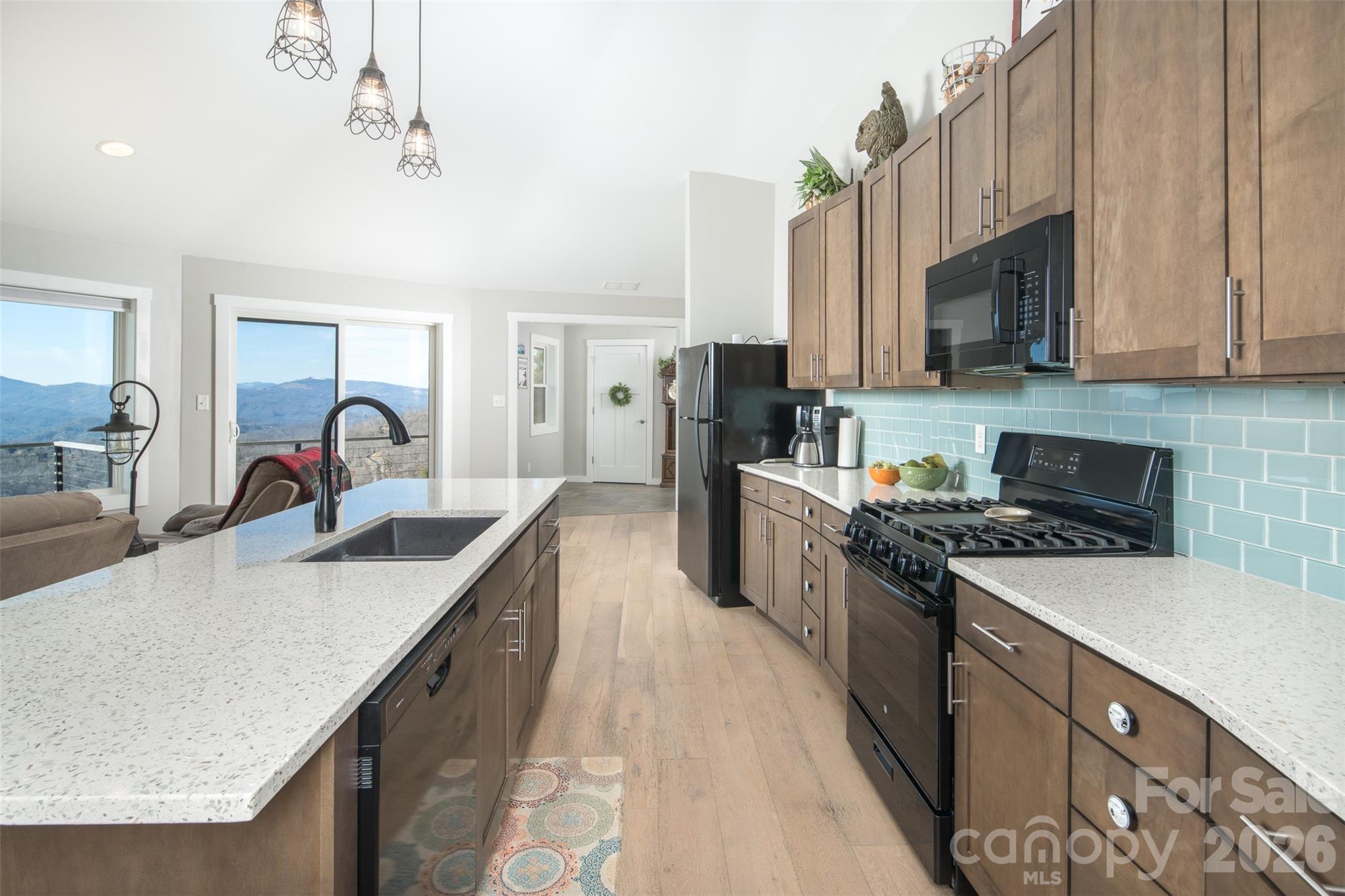 448 Howards Knob Road Boone, NC 28607 - Photo 17 of 38 a kitchen with stainless steel appliances granite countertop a sink stove and refrigerator