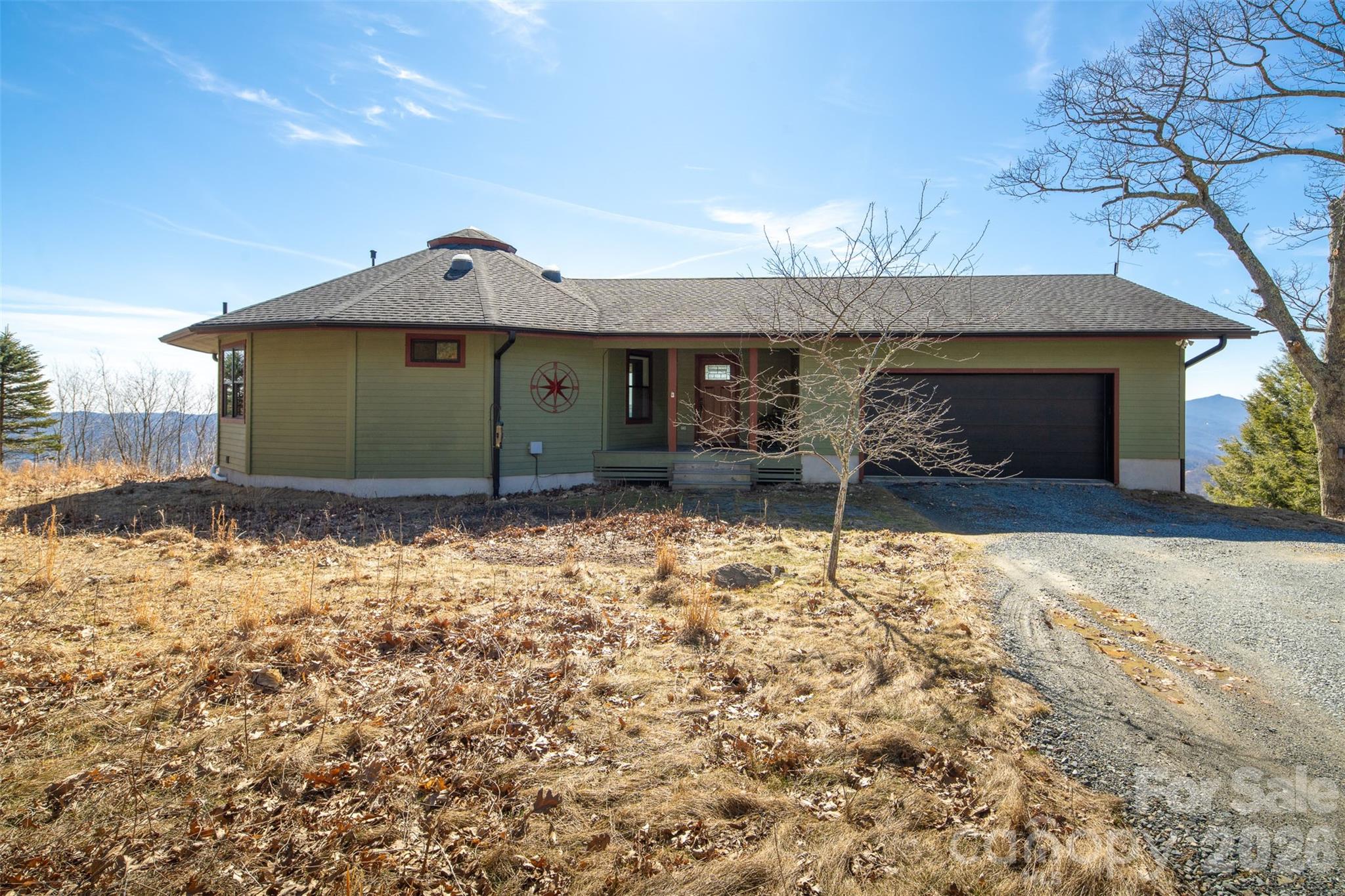 448 Howards Knob Road Boone, NC 28607 - Photo 6 of 38 a front view of a house with a yard and garage
