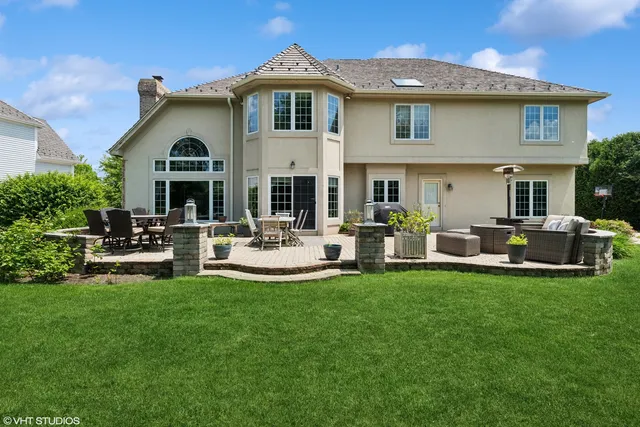 a view of a house with a yard porch and furniture