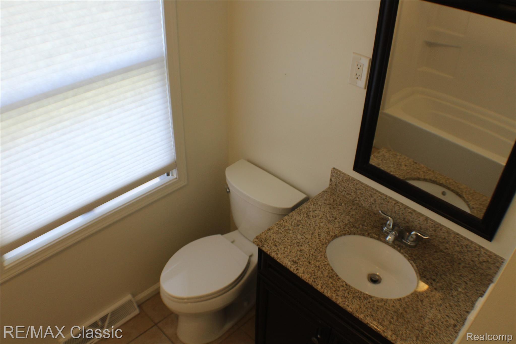 3625 Moberly Road Commerce Township, MI 48382 - Photo 10 of 19 Newer vanity, toilet and fixtures