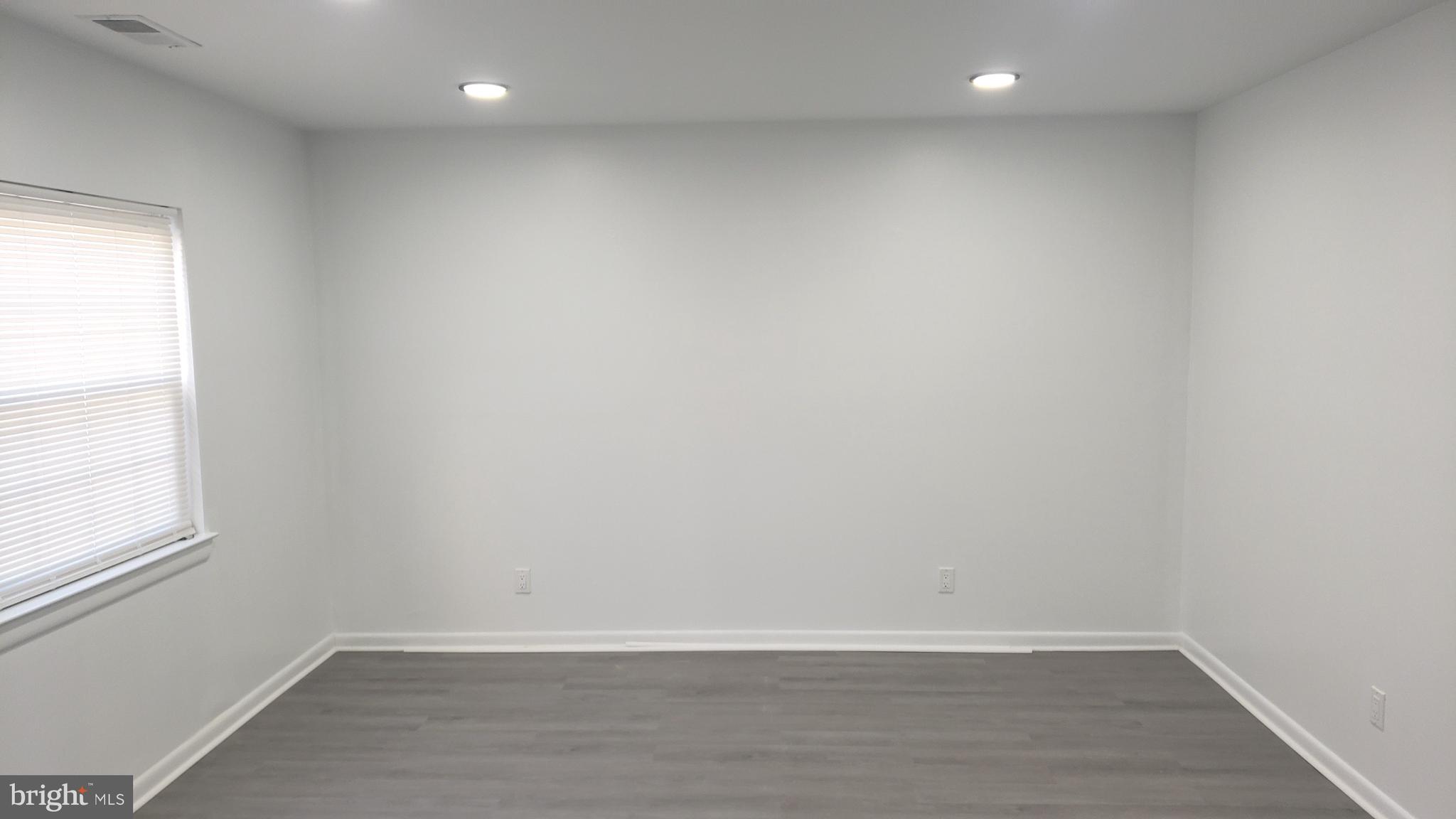 1906 Chelmsford Circle Newark, DE 19713 - Photo 2 of 14 a view of an empty room with wooden floor and a window