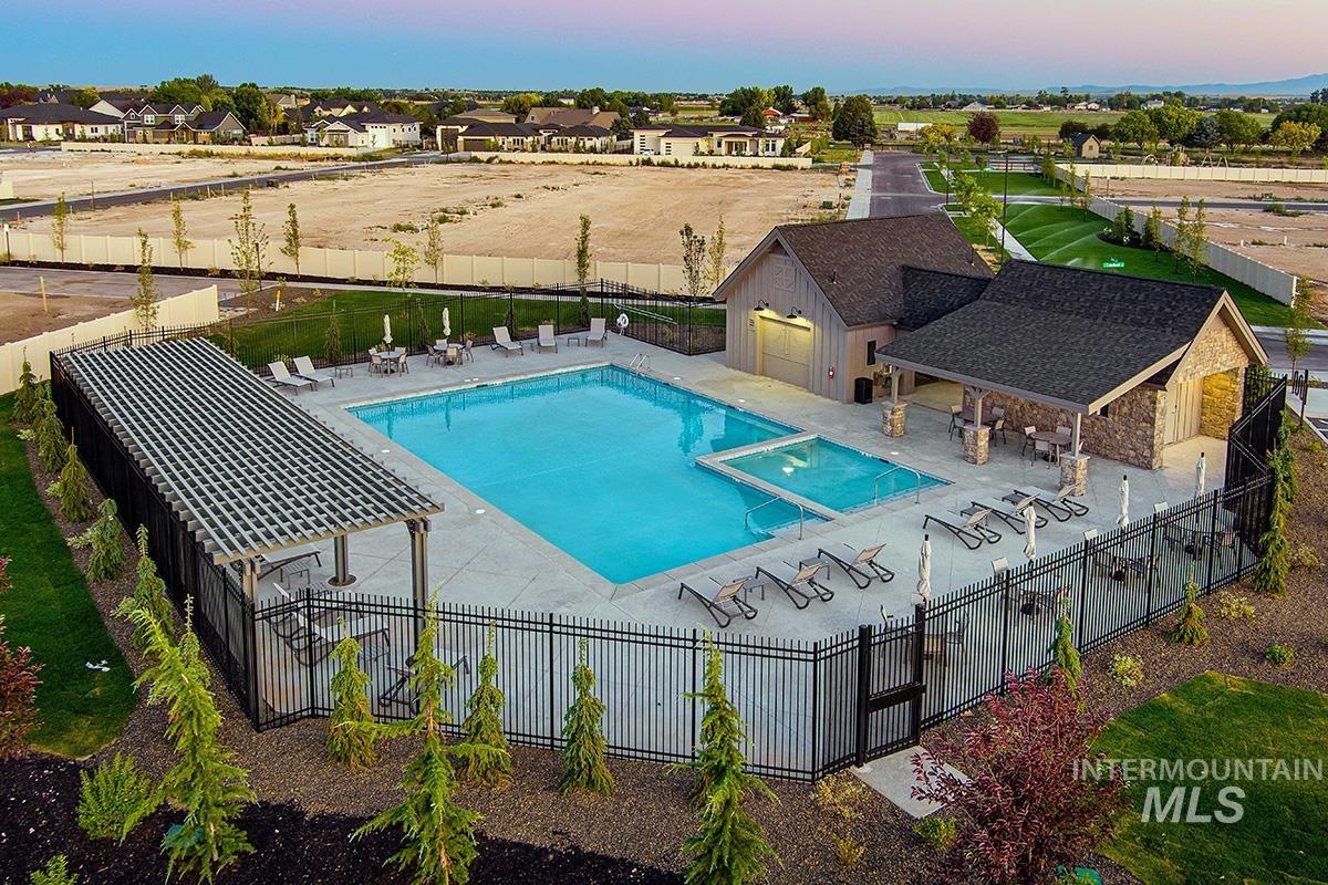7080 South Gamely Avenue Meridian, ID 83642 - Photo 21 of 30 Pool at dusk featuring a patio area and a pool with connected hot tub