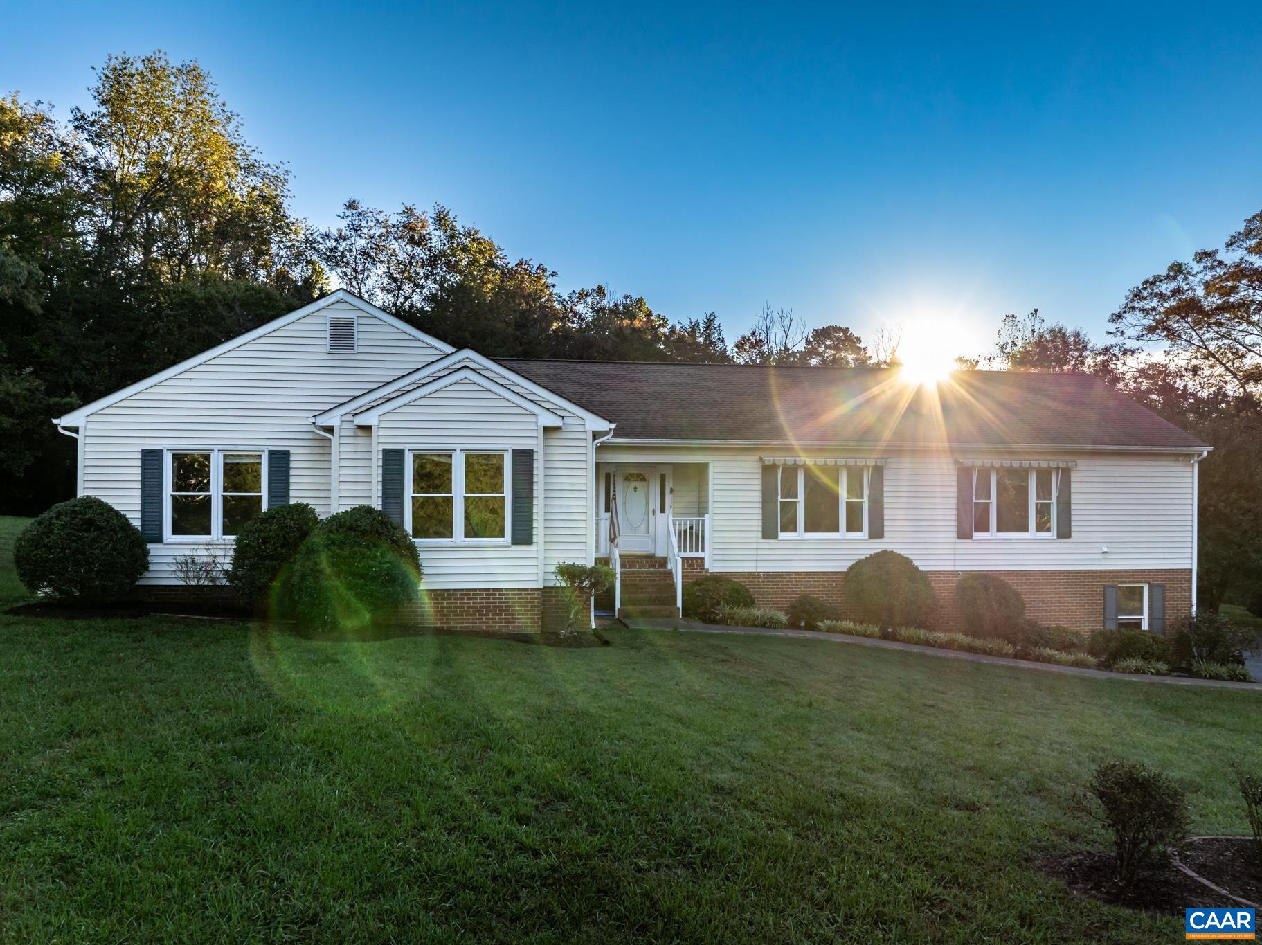 208 Rolling Hills Road Ruckersville, VA 22968 - Photo 1 of 56 a front view of a house with a garden and porch