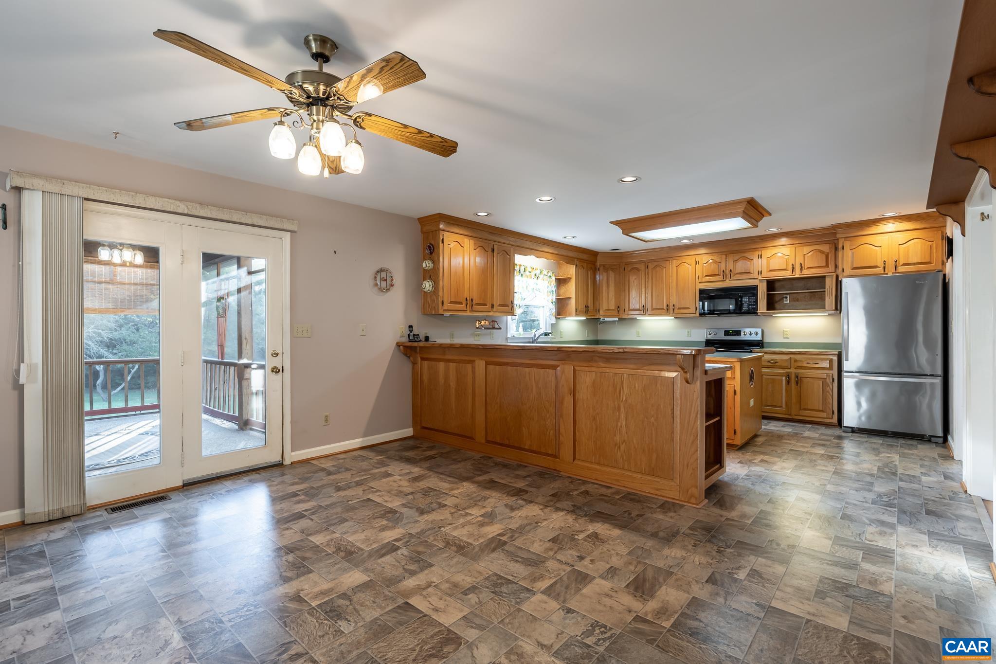 208 Rolling Hills Road Ruckersville, VA 22968 - Photo 12 of 56 a kitchen with stainless steel appliances granite countertop a sink cabinets and wooden floor