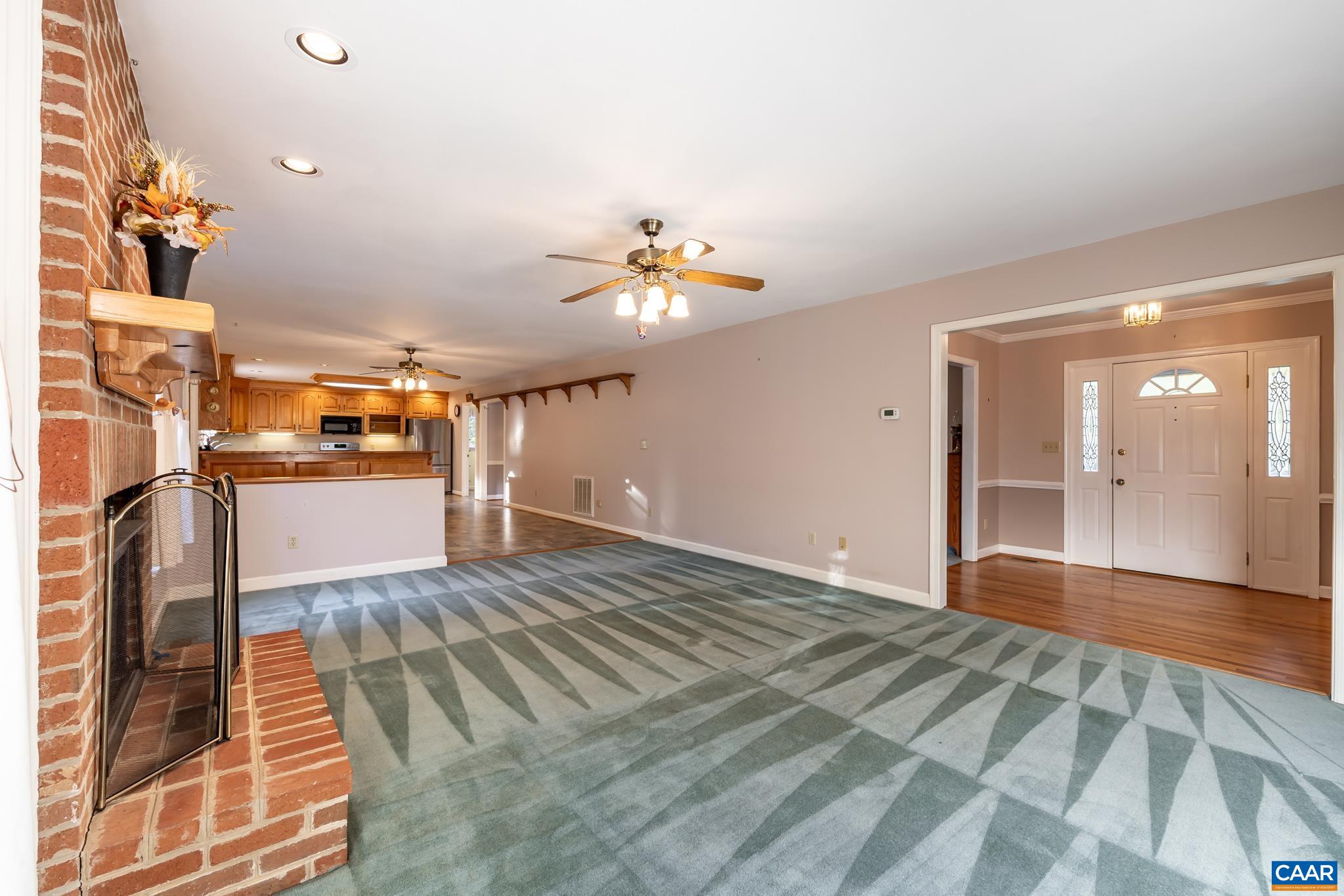 208 Rolling Hills Road Ruckersville, VA 22968 - Photo 15 of 56 a view of a living room a chandelier fan and wooden floor