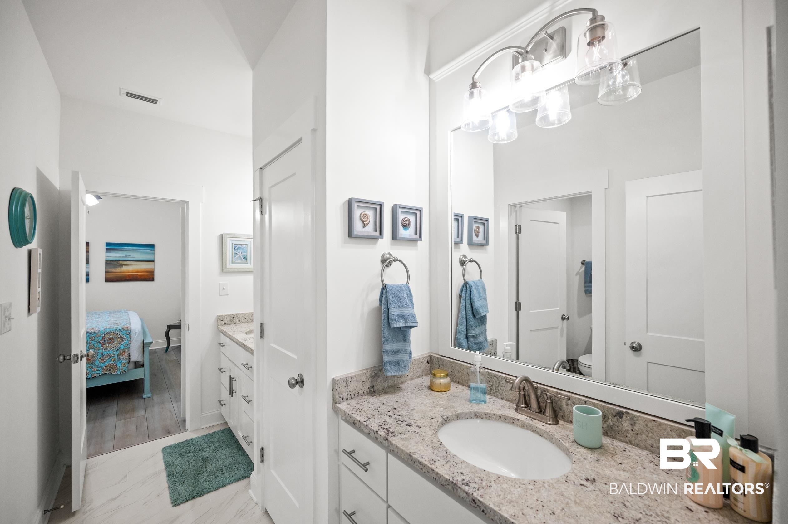 4601 Surrey Lane Orange Beach, AL 36561 - Photo 29 of 43 Bathroom featuring vanity, toilet, and hardwood / wood-style floors