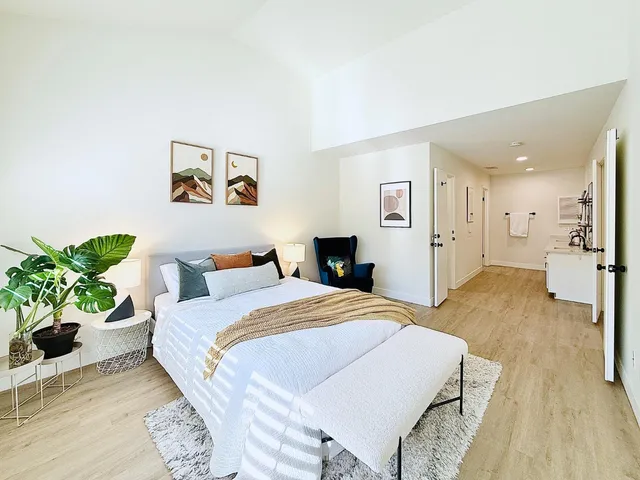 a spacious bedroom with a bed and a couch