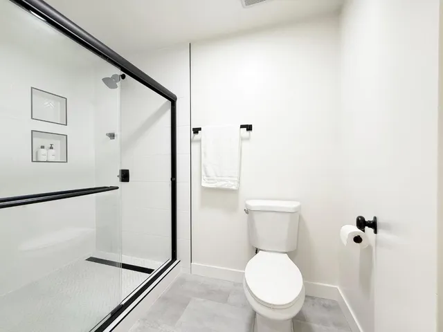 a white toilet sitting next to a bathroom sink