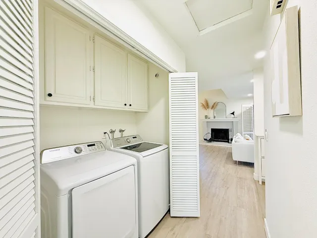 a view of washer and dryer with kitchen in the background