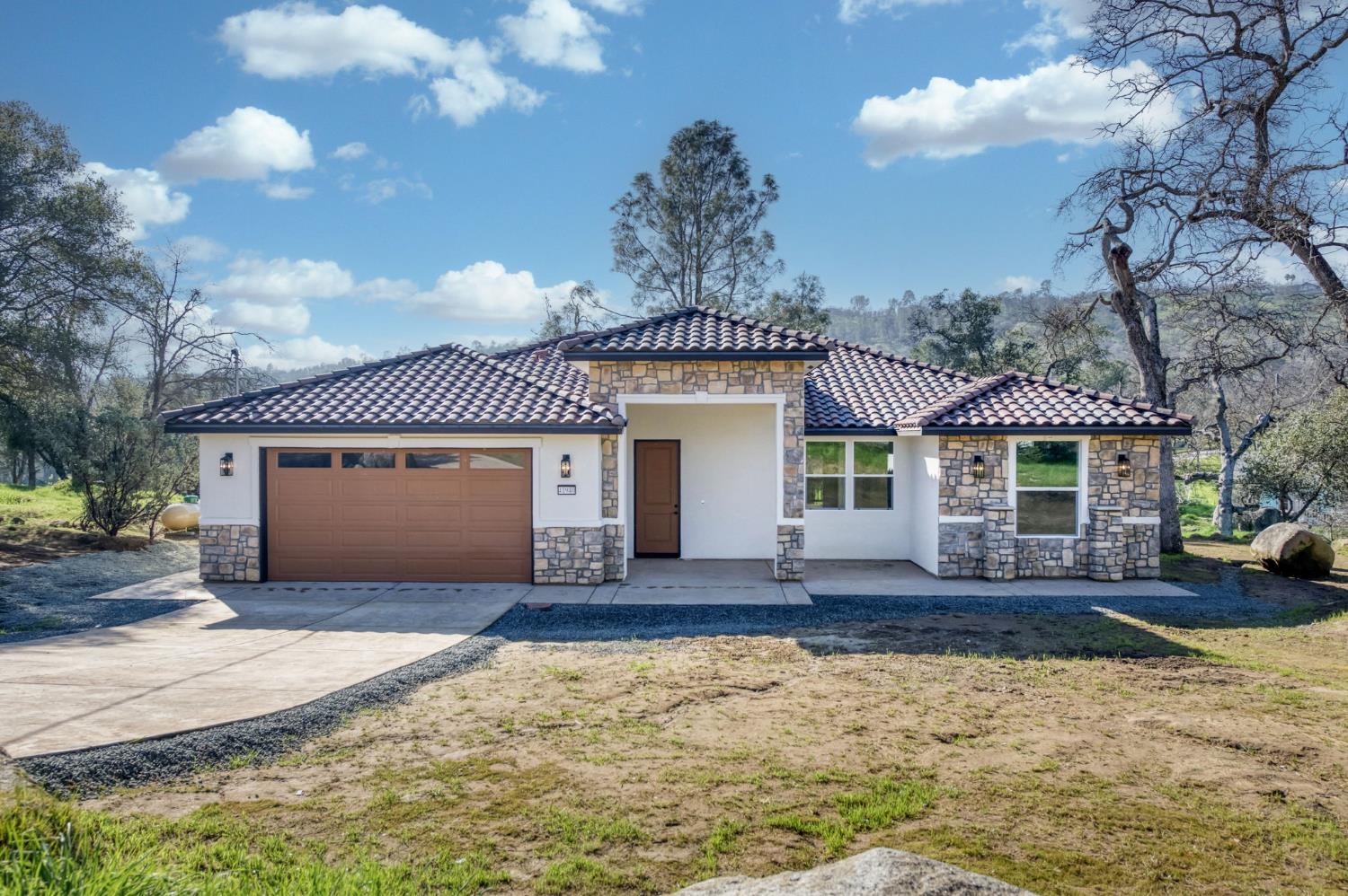 41940 Colt Court Coarsegold, CA 93614 - Photo 1 of 50 a front view of a house with a yard and garage