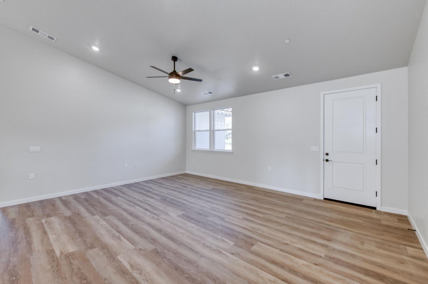 41940 Colt Court Coarsegold, CA 93614 - Photo 18 of 50 a view of an empty room with a window and wooden floor