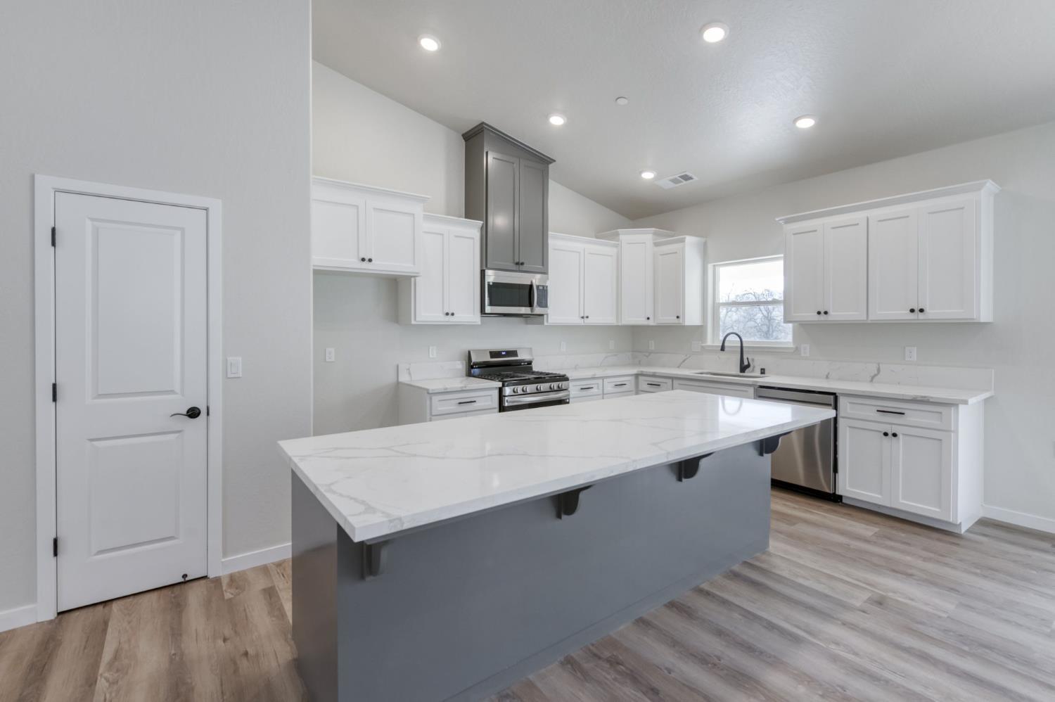 41940 Colt Court Coarsegold, CA 93614 - Photo 20 of 50 a kitchen with kitchen island sink stove and cabinets