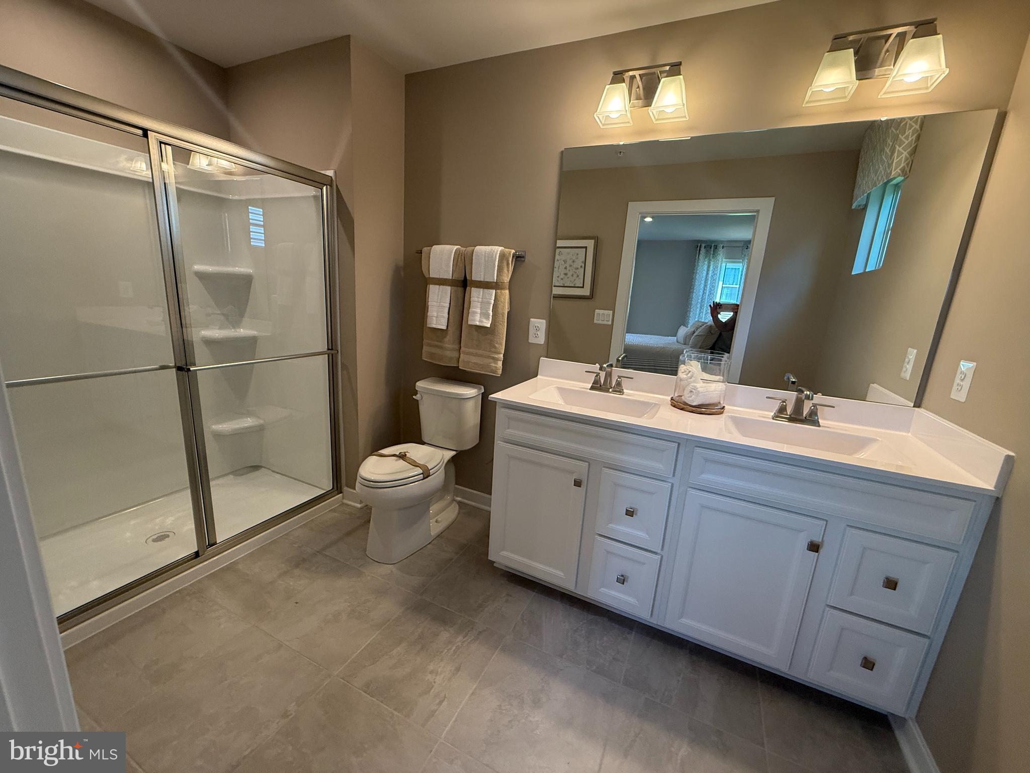 2506 Crown Point Circle Frederick, MD 21702 - Photo 13 of 21 a bathroom with a double vanity sink toilet and shower