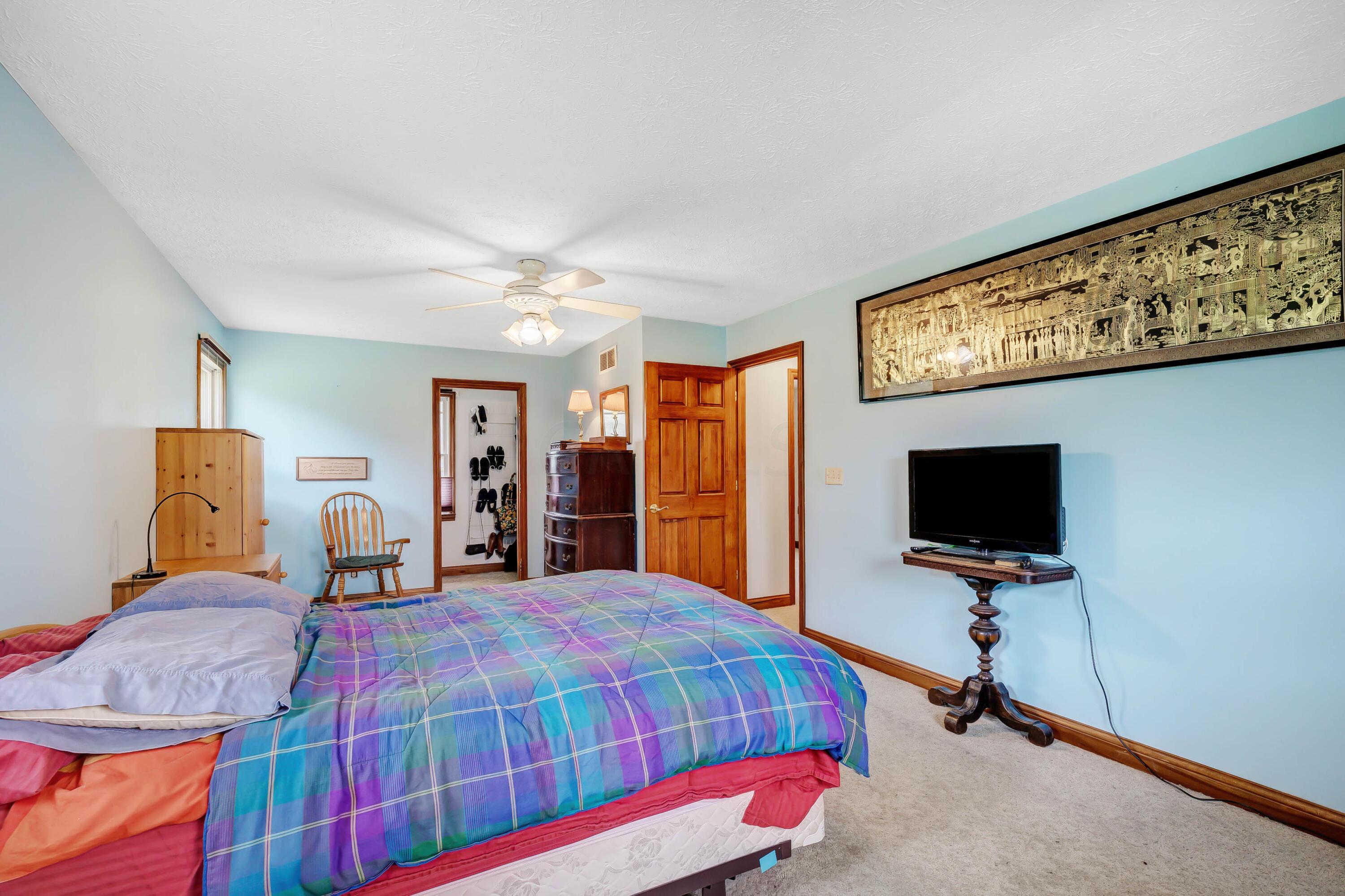 8558 Morris Road Hilliard, OH 43026 - Photo 8 of 74 • Tan carpet • Blue painted walls • Lighted ceiling fan • Up/down shades