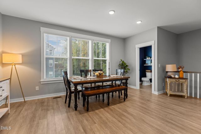 a kitchen with stainless steel appliances kitchen island granite countertop a stove a sink and a refrigerator