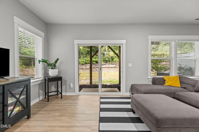 a spacious bedroom with a bed and a chandelier