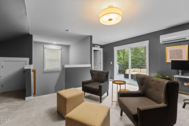 a view of a patio with couches chairs and wooden floor
