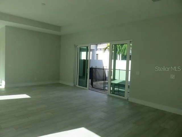 an empty room with floor to ceiling windows