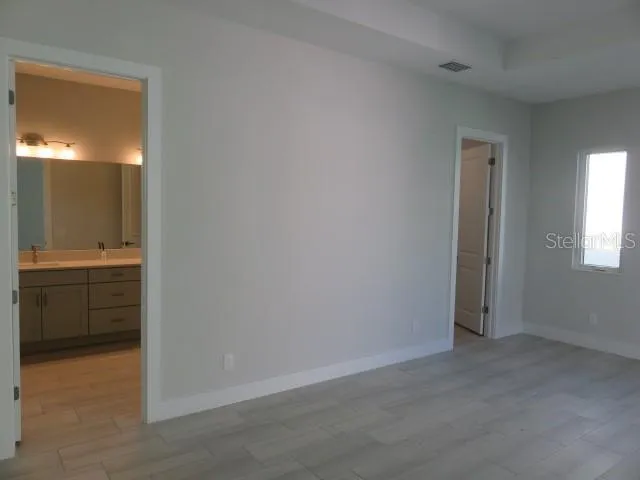 an empty room with a bathroom and a sink