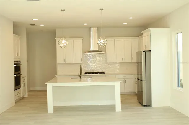 a bathroom with a sink mirror and a shower
