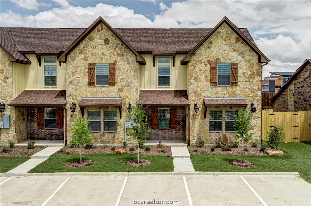 4293 Commando Trail College Station, TX 77845 - Photo 1 of 1 a view of a brick house with a yard plants and a table