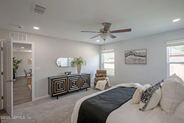 a view of walk in closet with clothes