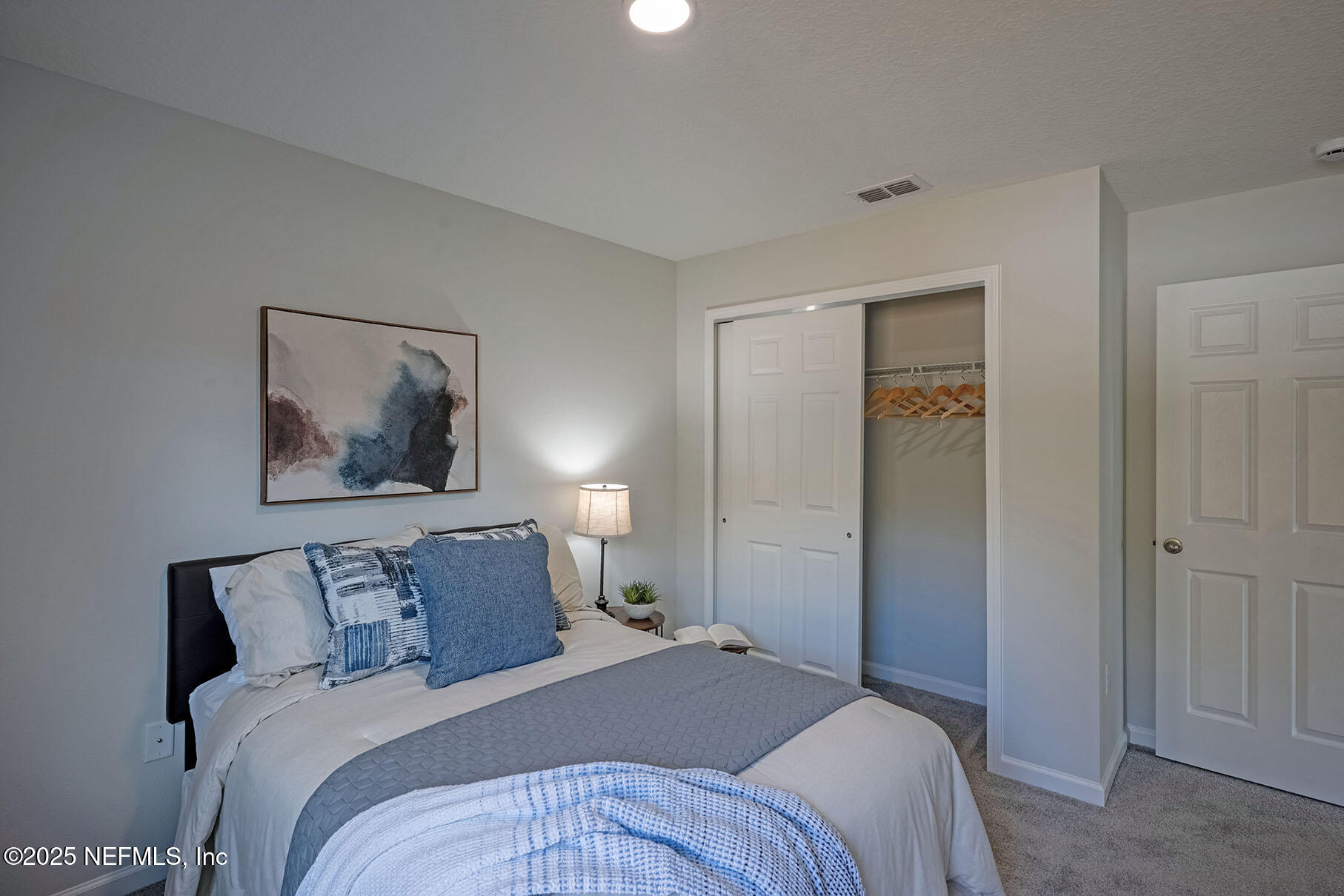 1235 Jewelstone Lane Jacksonville, FL 32221 - Photo 7 of 32 a bedroom with a bed and a painting on the wall