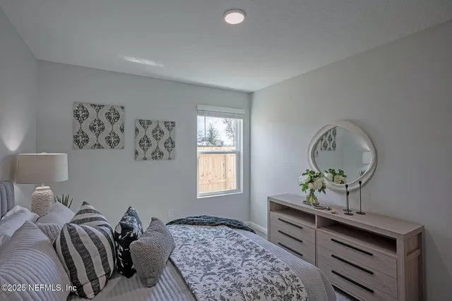 a bed room with a bed and a window