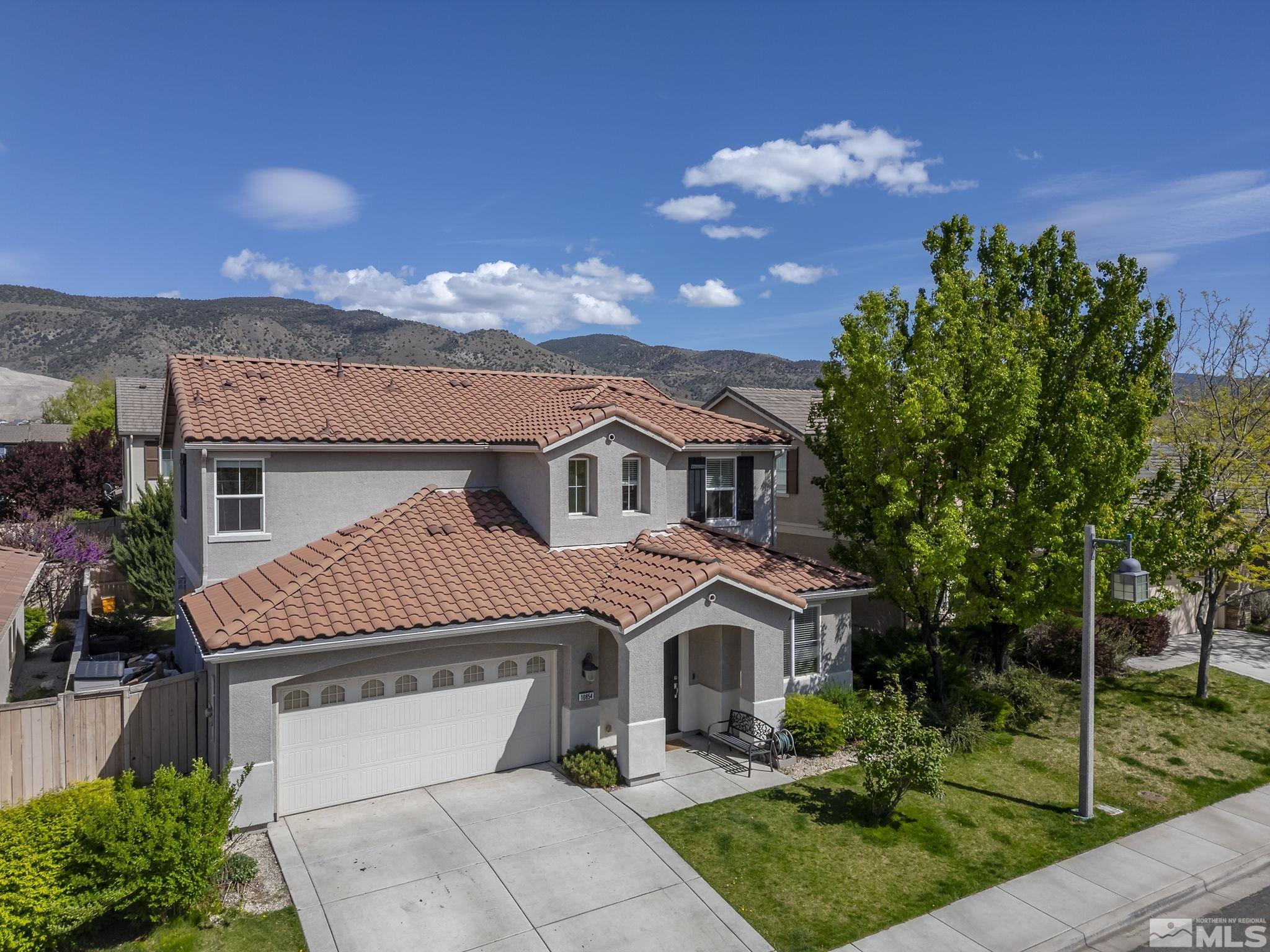 10854 Oakhaven Drive Reno, NV 89521 - Photo 34 of 38 a front view of a house with a garden