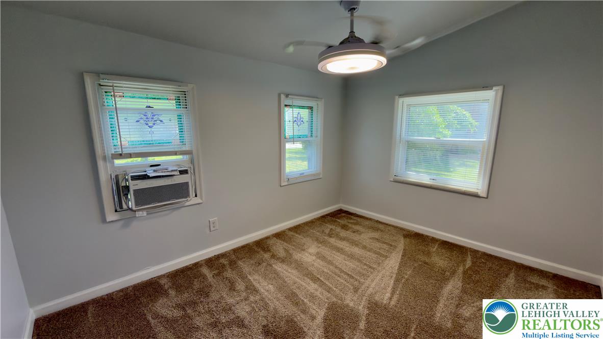 246 Poplar Street Bath, PA 18014 - Photo 12 of 34 A well-lit bedroom features plush carpeting and multiple windows.