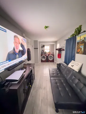 a living room with furniture and a flat screen tv