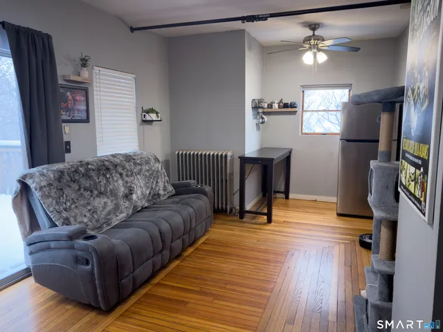 a living room with furniture and a wooden floor