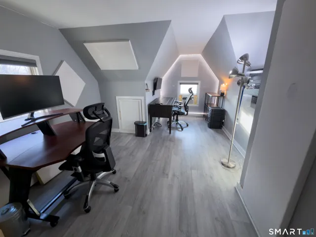 a view of a livingroom with furniture and a workspace