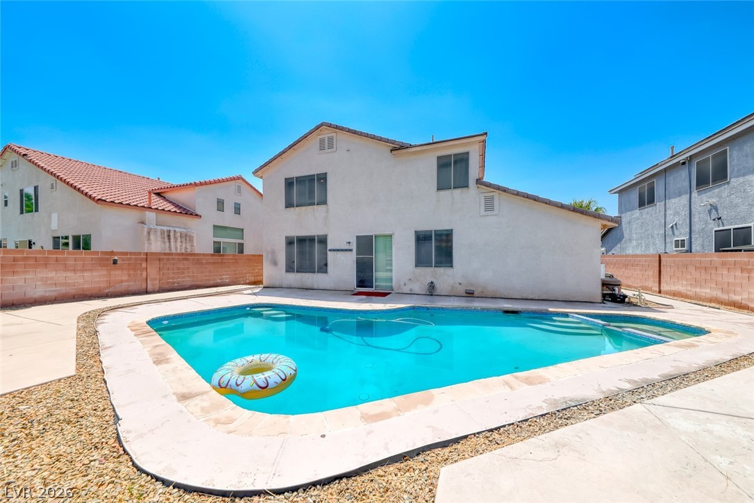 208 Glendon Street Henderson, NV 89074 - Photo 41 of 41 Enjoy outdoor leisure with a refreshing in-ground pool adjacent to the property's rear facade.