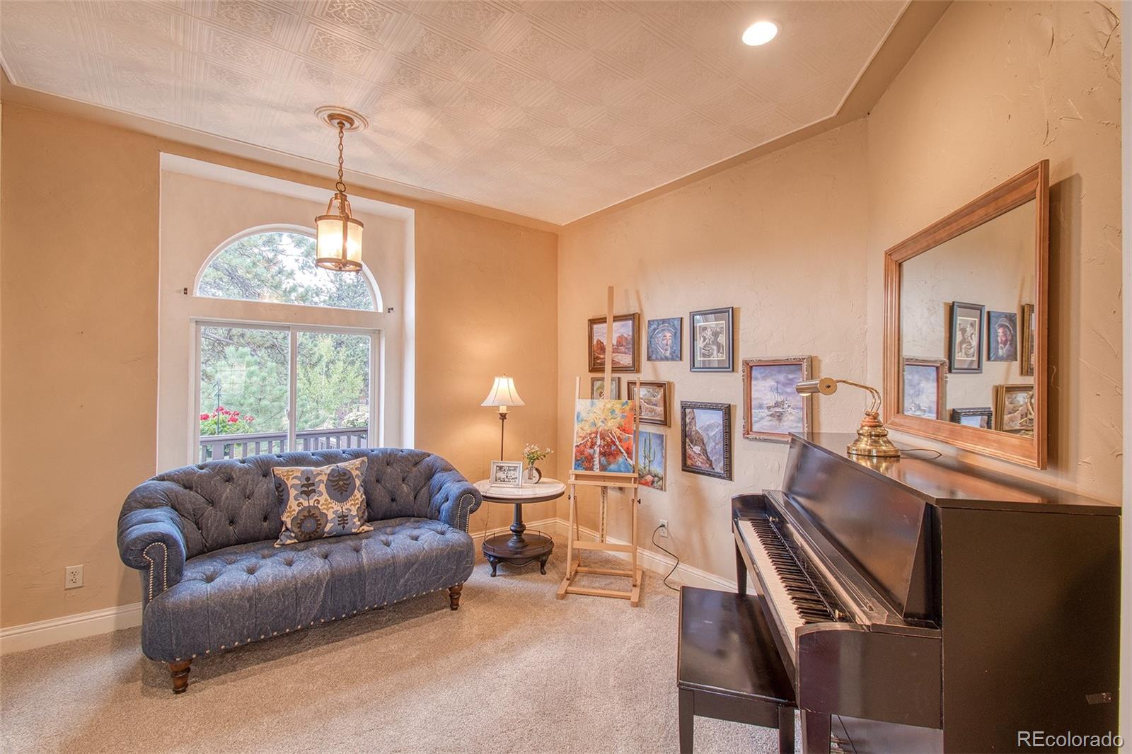 416 Conestoga Road Bailey, CO 80421 - Photo 13 of 40 a living room with furniture a window and a chandelier