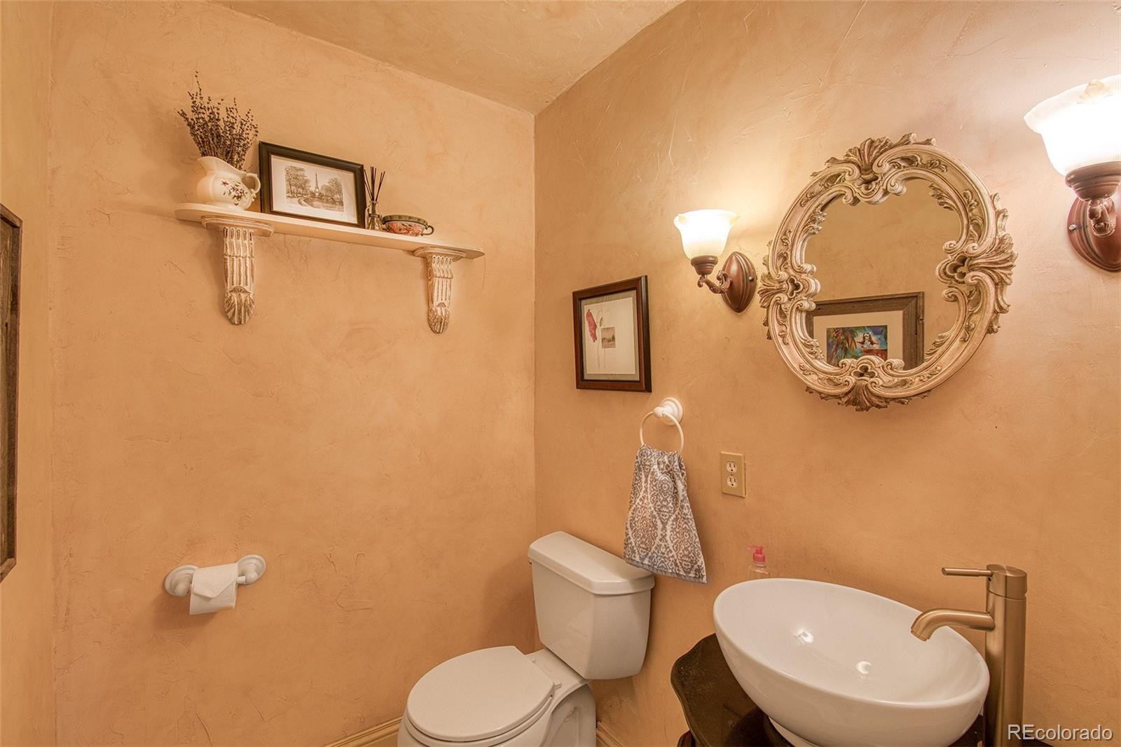 416 Conestoga Road Bailey, CO 80421 - Photo 15 of 40 a bathroom with a toilet a sink and mirror