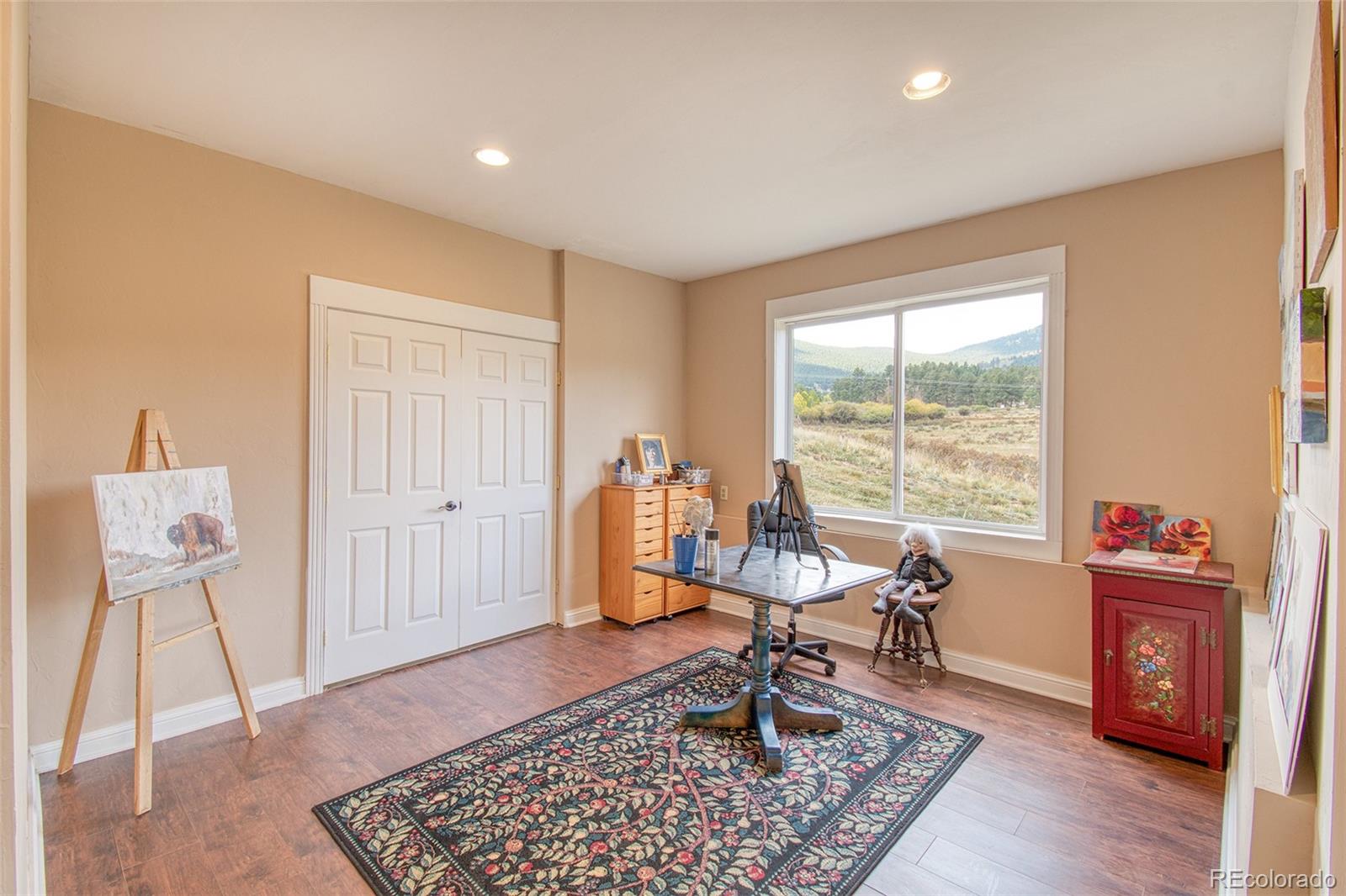 416 Conestoga Road Bailey, CO 80421 - Photo 28 of 40 a living room with furniture and wooden floor