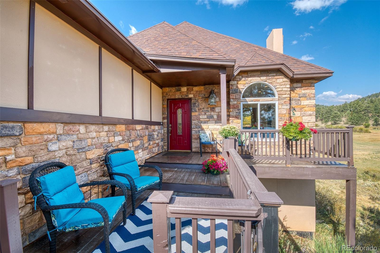 416 Conestoga Road Bailey, CO 80421 - Photo 5 of 40 a view of a chair and tables in the balcony